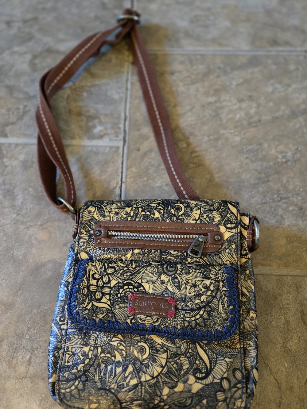 Sakroots Black Floral Crossbody with Tan Strap and Blue Trim.Has Some Pen Marks.